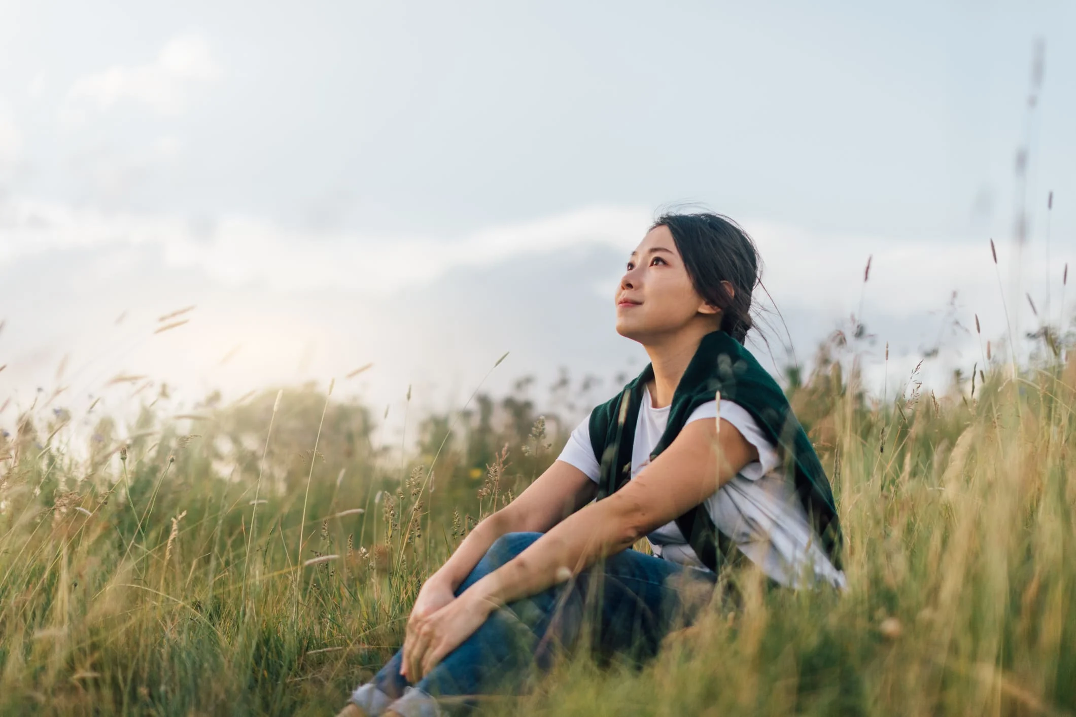 Mindful-mindfulness-enjoying-nature-woman-sitting enjoying nature-savouring-savoring